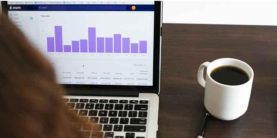Woman checking sales data on Shopify