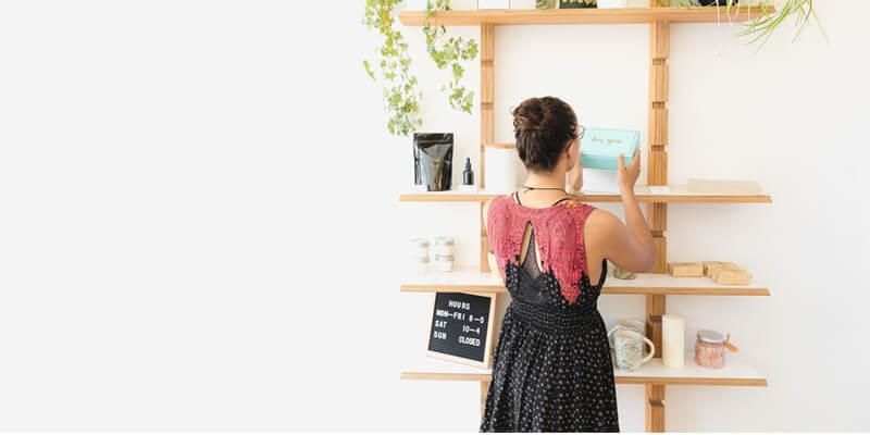 Woman arranging goods on shelf