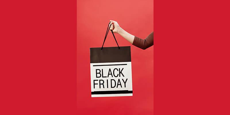 Woman holding bag promoting BFCM sale
