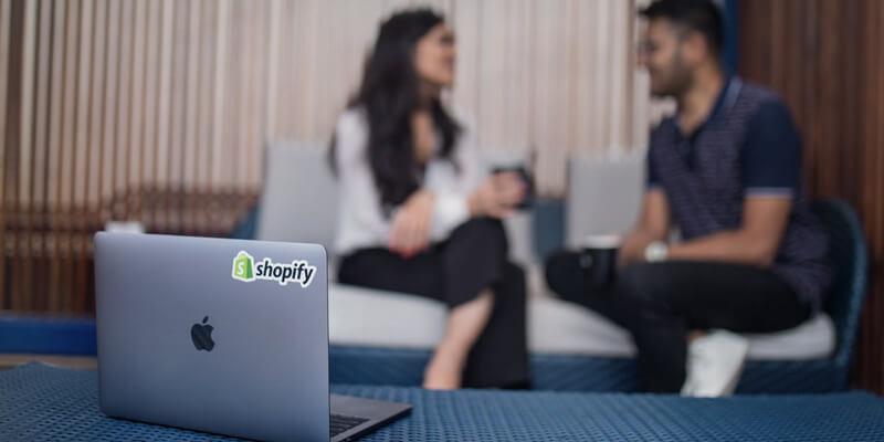 Shopify laptop at small meeting