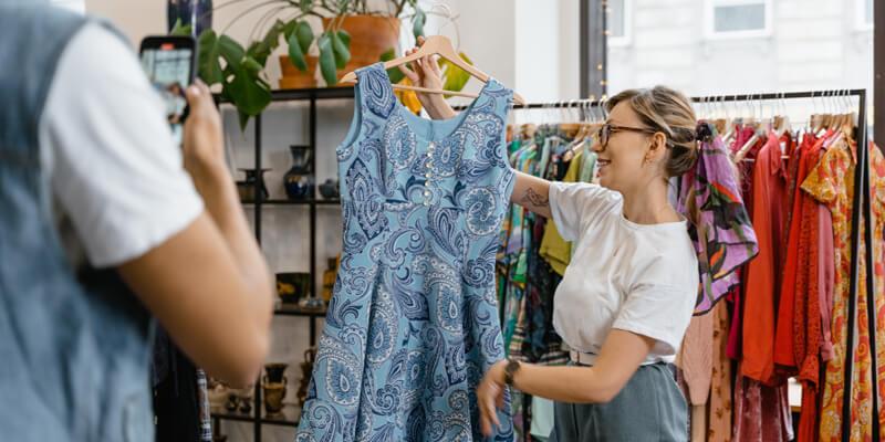 Woman putting a dress on sale