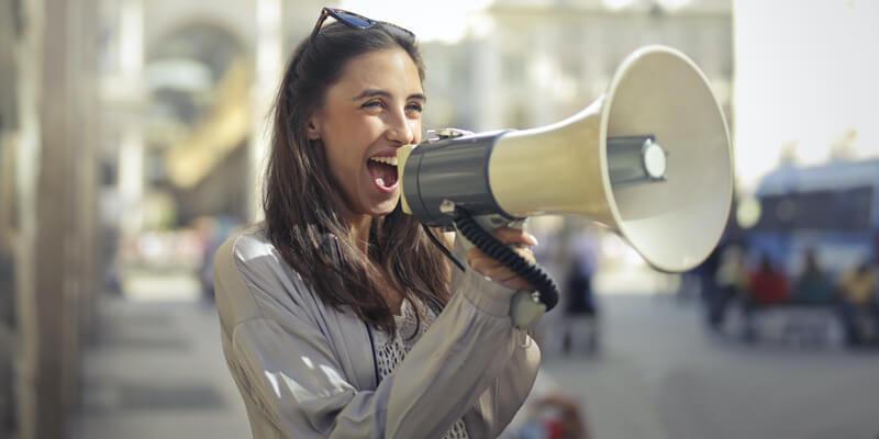 Woman posing with a loudspeaker