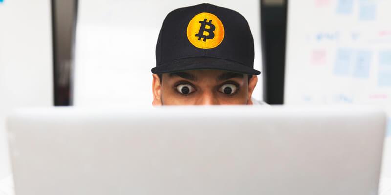 Shocked bitcoin investor on laptop